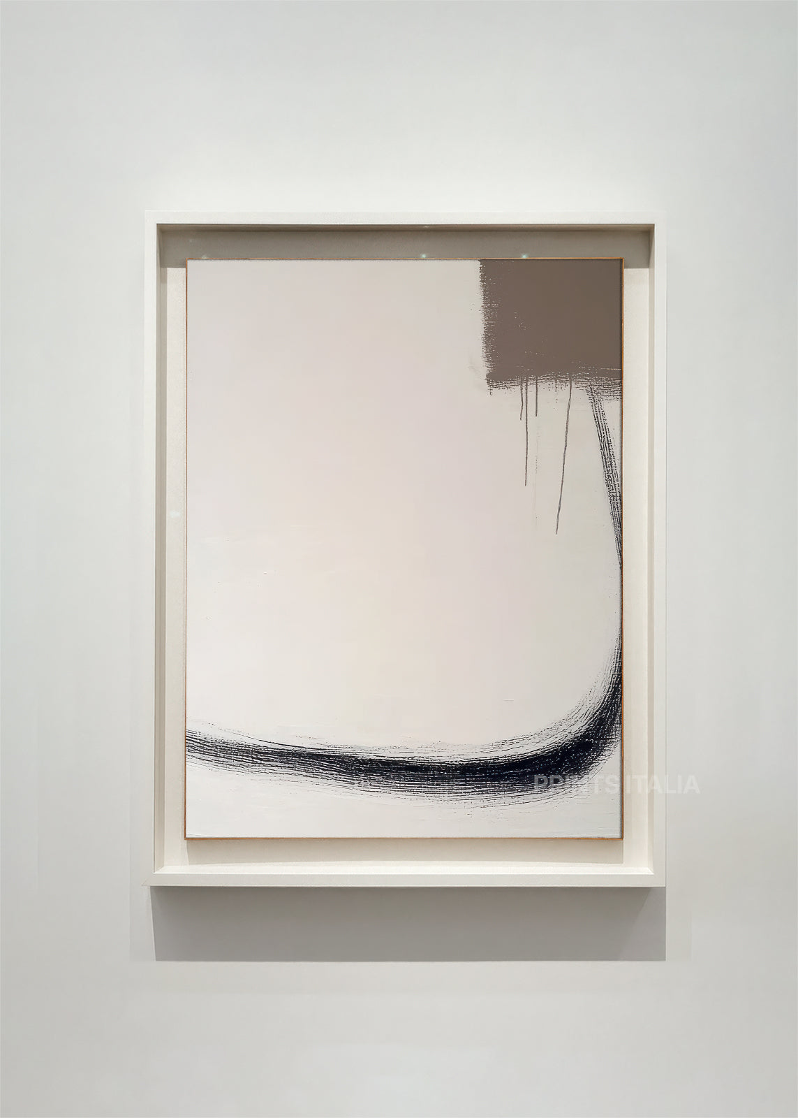 CAELUN – framed minimalist abstract art print with taupe and cream fields, sweeping graphite curve, and bold textured block, displayed in a modern gallery