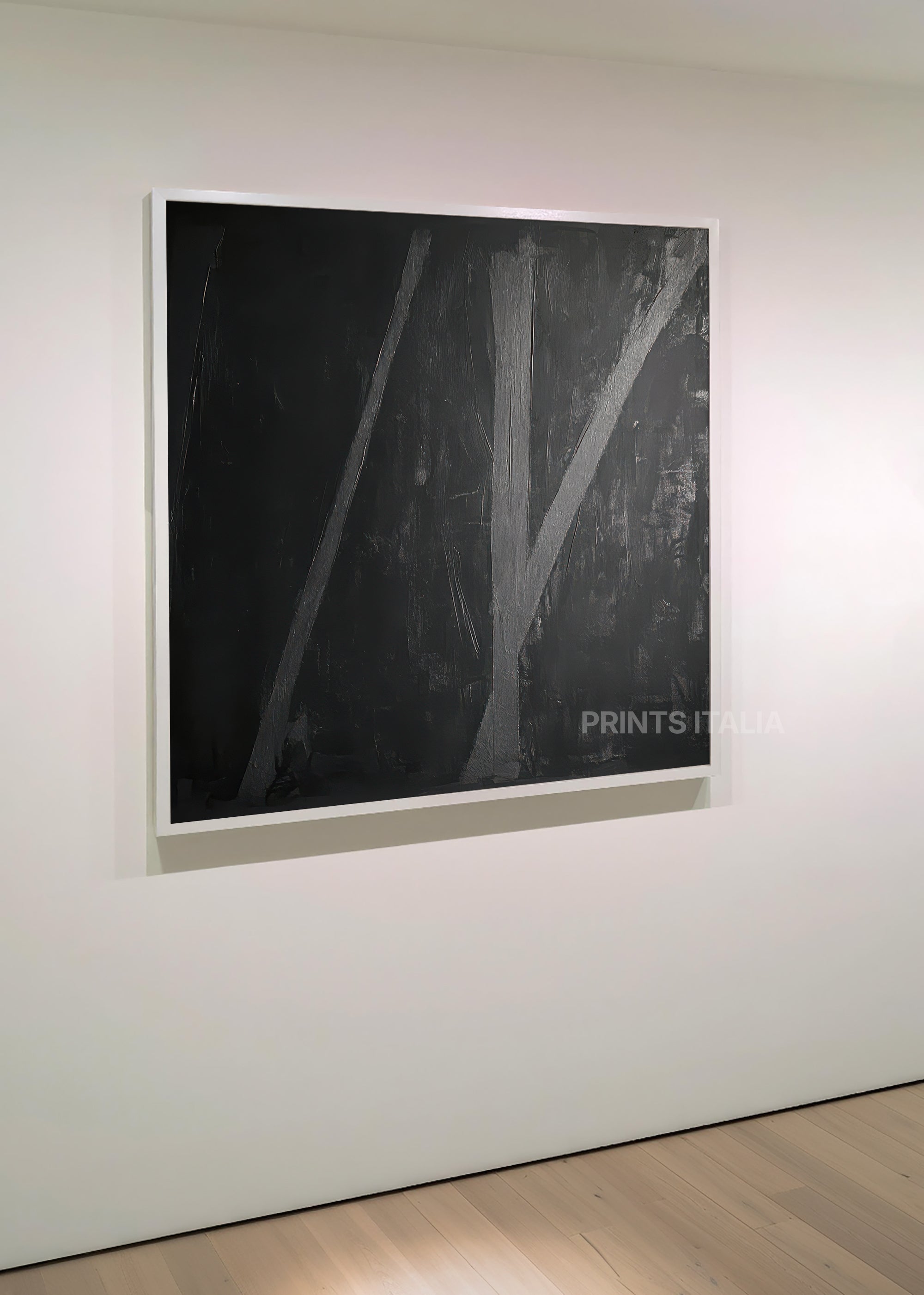RIMA art print featuring minimalist charcoal composition, bold intersecting lines, and textured depth, leaning against a soft gray wall