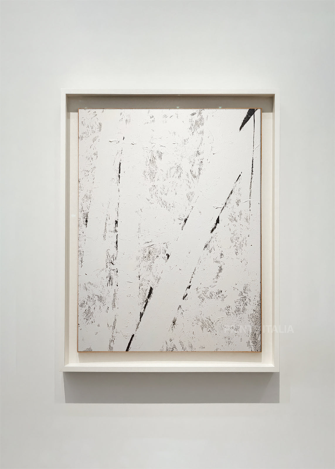 VESARI – framed minimalist abstract art print with crisp white field, bold diagonal black lines, and distressed texture, displayed in a modern gallery